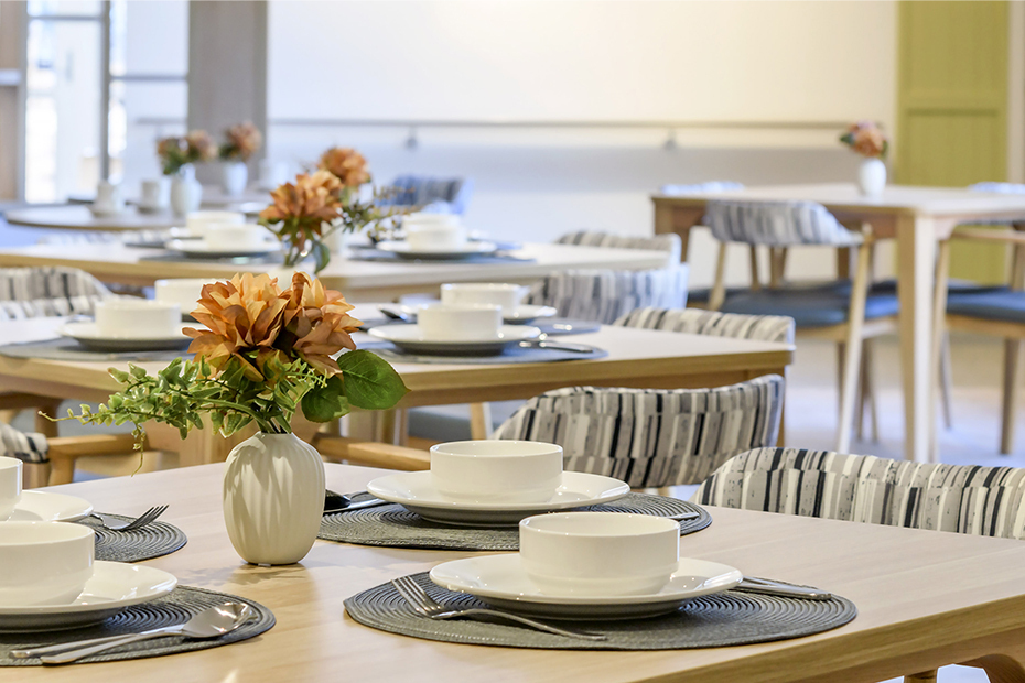 A table adorned with a vase of colorful flowers, adding a touch of elegance and vibrancy to the room.