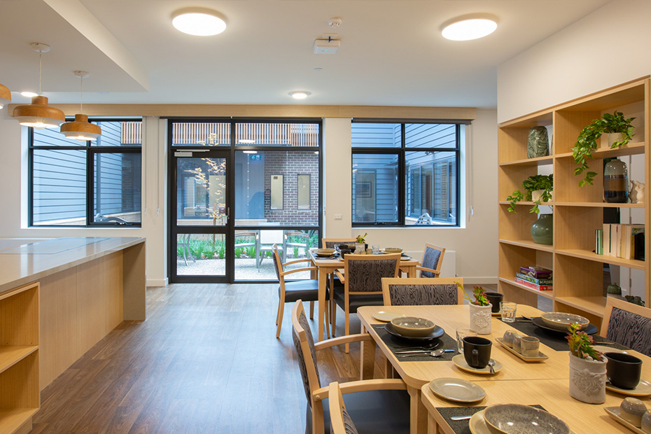 A kitchen with a table and chairs, providing a cozy space for dining and gathering.