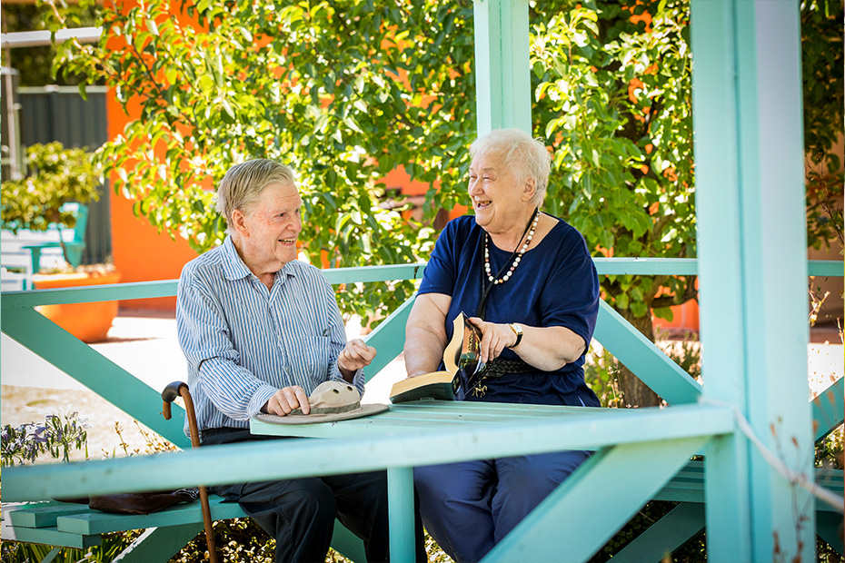 An older couple enjoying a peaceful moment together on a bench, cherishing their time and creating beautiful memories.