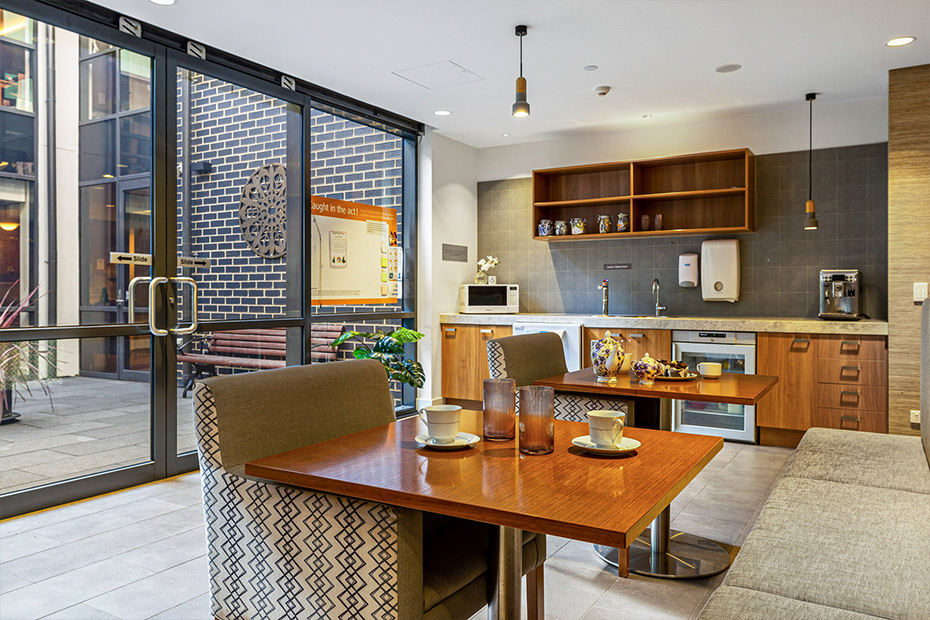 A spacious kitchen and dining area with a lovely view of a patio, perfect for enjoying meals and entertaining guests.