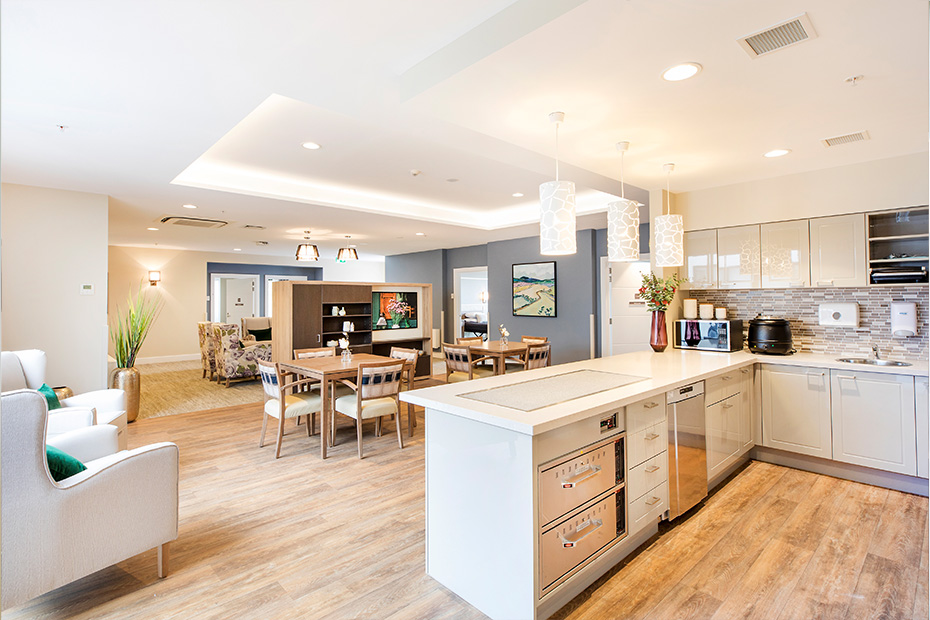 A cozy kitchen and dining room in a home, featuring modern appliances and a stylish dining area.