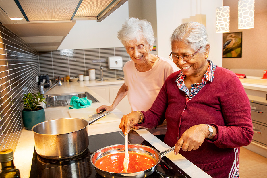 Two residents cooking.