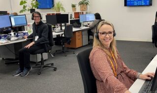 A woman sitting at a desk answering phones