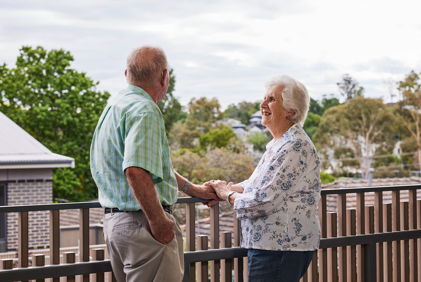 An older Australian couple enjoying the view from a balcony, cherishing their time together.