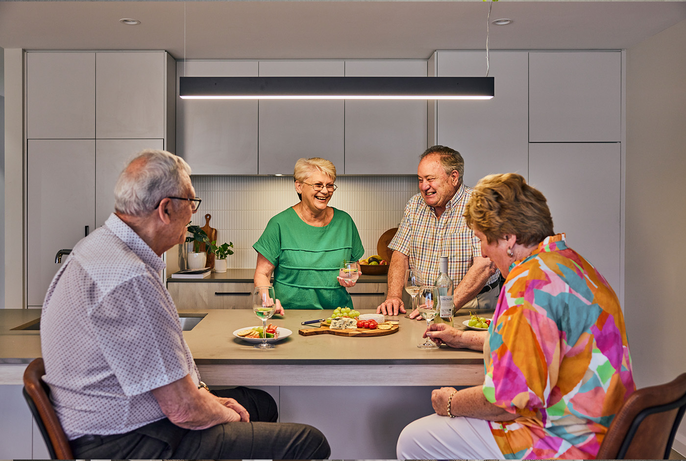 A diverse group of individuals enjoying a meal together at a table, sharing food and engaging in conversation.