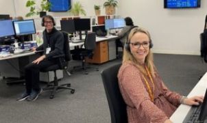 A woman sitting at a desk answering phones