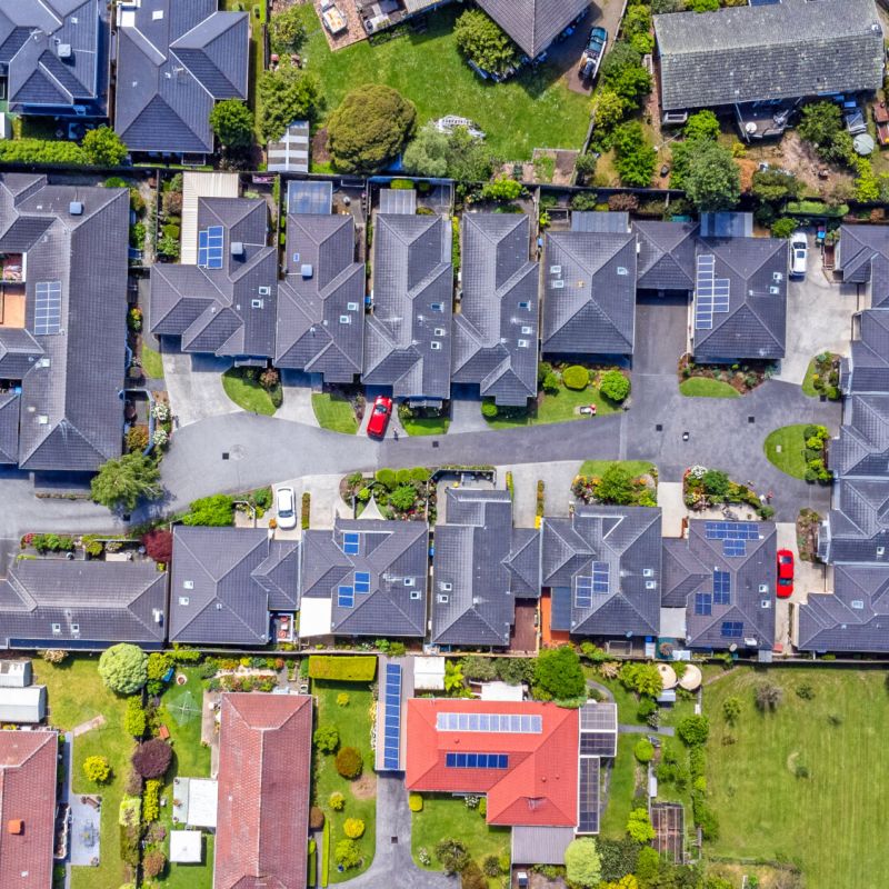 Aerial view of retirement community rooftops surrounded by established gardens