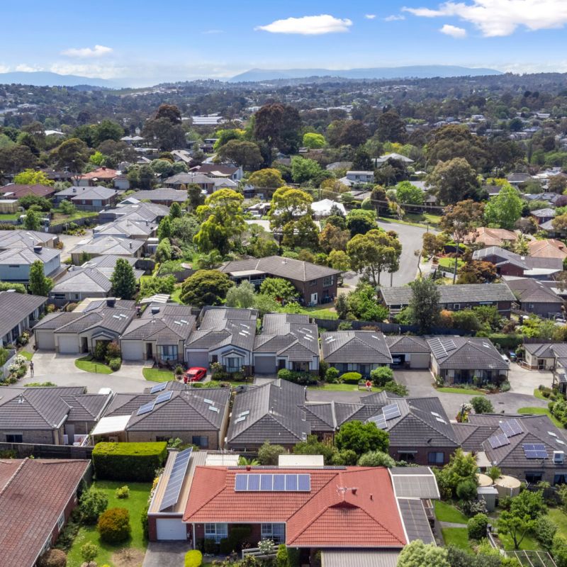 Elevated view overlooking retirement community with homes, trees, and surrounding neighbourhood