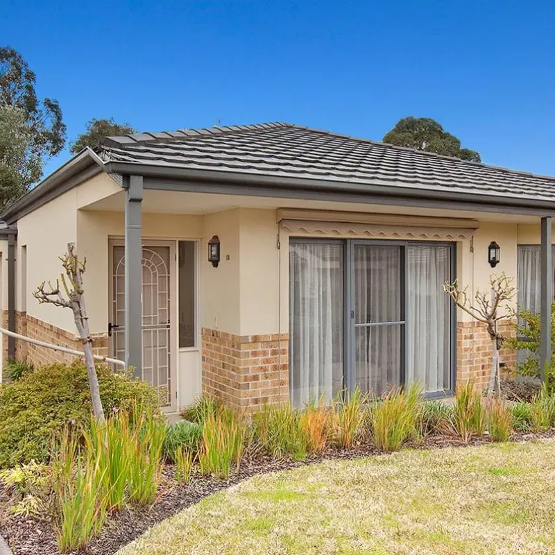 Single level unit at The Oaks Retirement Community with front garden and driveway